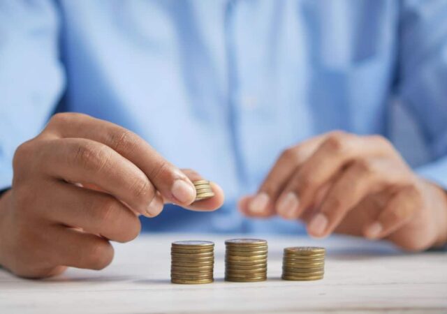 Man placing coins into different size piles