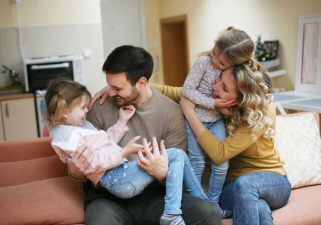 A family embrace on the sofa