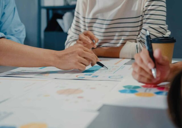 Financial advisers creating a financial plan around a table.