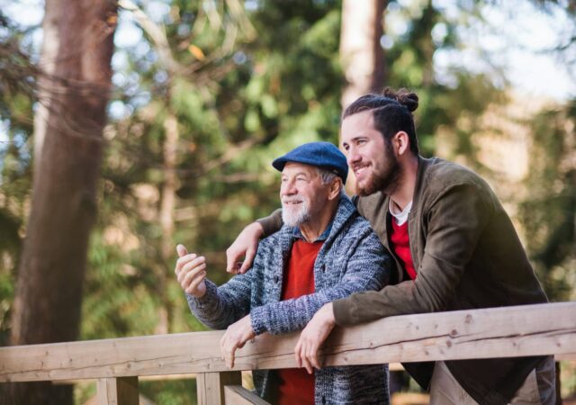 A retired man next to his son who is planning for retirement.