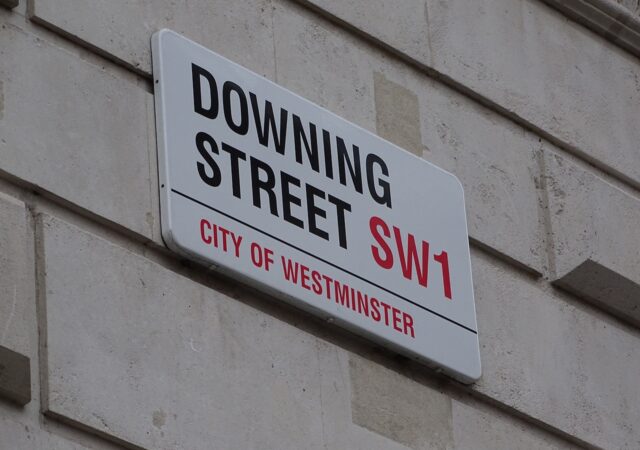 The Downing Street road sign that displays "DOWNING STREET SW1 - CITY OF WESTMINSTER"